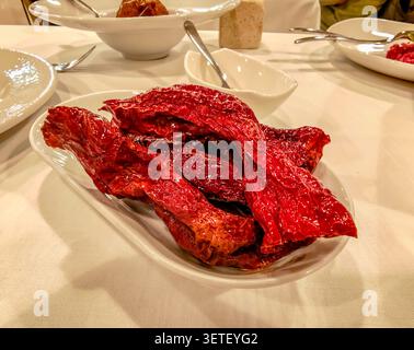 Peperoni Cruschi, peperone crusco served on restaurant plate in Matera, traditional Basilicata cuisine, crispy dried peppers, local gastronomy Stock Photo