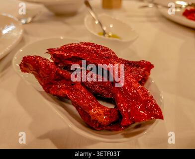 Peperoni Cruschi, peperone crusco served on restaurant plate in Matera, traditional Basilicata cuisine, crispy dried peppers, local gastronomy Stock Photo