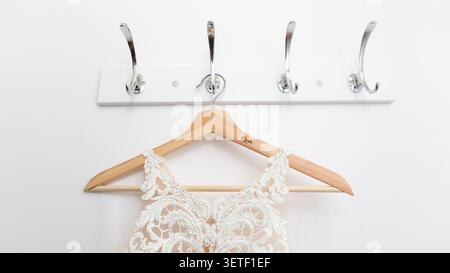 Bride Wedding Dress on Wooden Hanger Close Up Stock Photo
