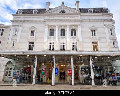 A low-angle view of the historic Royal Lyceum Theatre featuring neoclassical architecture, white masonry, and a glass-fronted entrance. Stock Photo