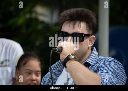 Young Cuban man with Down syndrome singing into a microphone during a unique social project performance in Ciego de Avila, Cuba Stock Photo