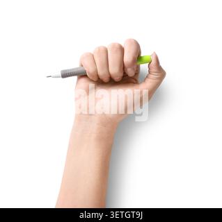 Female hand with green pen on white background Stock Photo