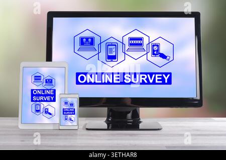Online survey concept shown on different information technology devices Stock Photo