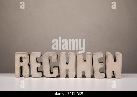 Math from German word RECHNEN displayed with decorative letters on table Stock Photo