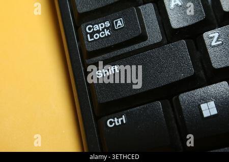 Close Up of The Caps Lock, Shifr, Ctrl, Windows, Keys on a Black Keyboard with Alphabet Keys Stock Photo