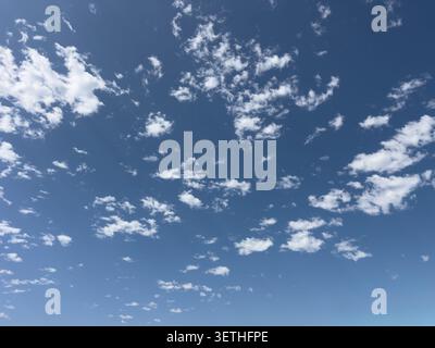 A view of the blue sky featuring clouds in a small bushy or patchy design. Stock Photo