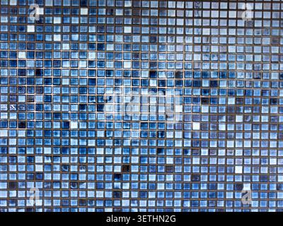 A view of small abstract blue ceramic tile on a wall, as a background. Stock Photo