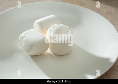 A view of a pile of marshmallows, on a plate. Stock Photo