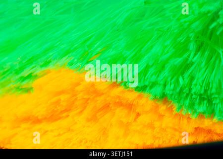 A macro abstract image of glowing green and yellow fibers creates a vivid fluorescent texture suitable for backgrounds and science concepts. Stock Photo