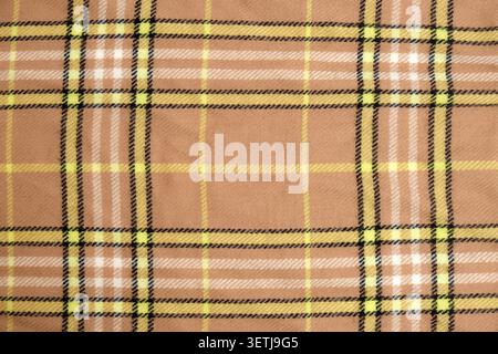 Brown tartan fabric with yellow and white stripe pattern. Soft textile texture for autumn fashion clothing design. Woven wool material background for Stock Photo
