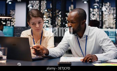 Diverse group of business professionals working together in workspace, collaborating on project assignments. Staff developing strategic agenda to drive company growth and success. Stock Photo