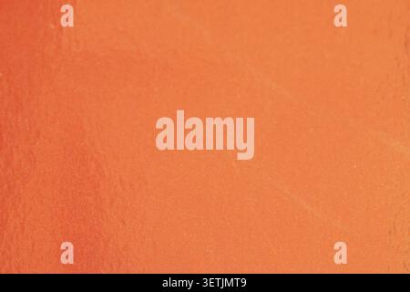 Orange metallic paper texture with fine grain and warm gradient. Stock Photo