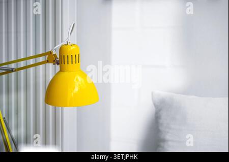 Minimal interior of living room or office with blank white wall, pillow, yellow lamp, space for text Stock Photo