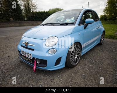 front view Light blue fiat 500 abarth parked on a gravel roadside in the UK Stock Photo