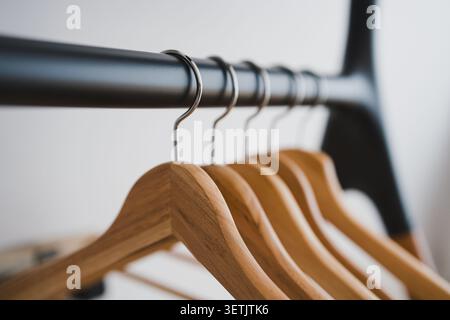 Wooden Clothes Hangers on Rack with Shallow Depth of Field Stock Photo