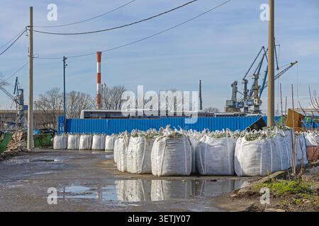 Broken Glass Bottles in Large White Sacks Material for Recycling at Industrial Facility Stock Photo