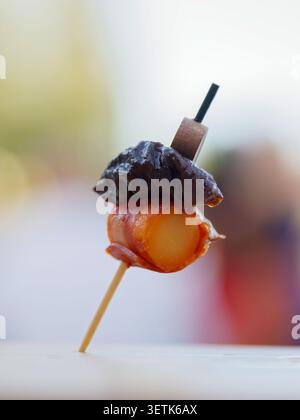 Freshly grilled shrimp served as gourmet appetizers during a catered cocktail reception in France, with chefs preparing and serving the seafood live. Stock Photo