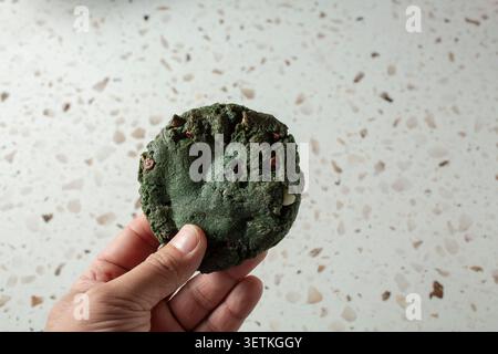 A view of a hand holding a monster cookie. Stock Photo