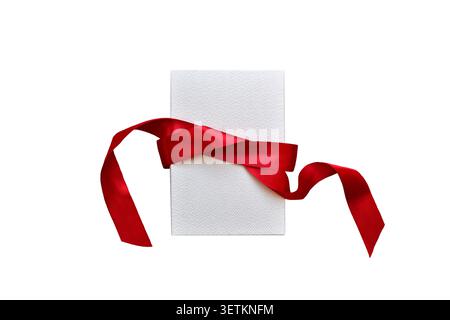 White gift box with red ribbon isolated cutout on white Stock Photo
