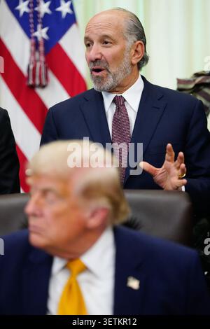 President Donald Trump listens as Commerce Secretary Howard Lutnick ...