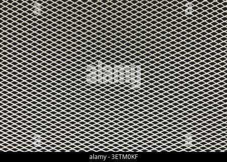 Close up of expanded metal mesh texture with geometric pattern. Industrial steel grid background for design, construction and technology concepts. Stock Photo