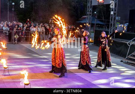 Borovichi, Russia - July 5, 2025: Dancing fire show artists at spectacular nighttime performance in dramatic light, fiery movements under night sky, s Stock Photo