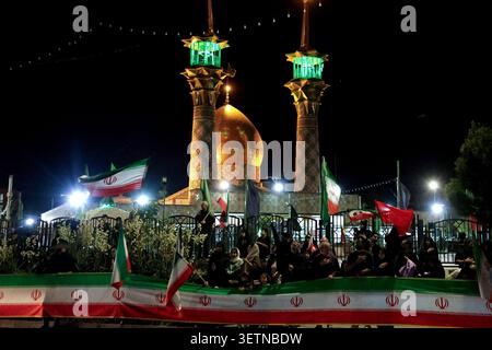 June 23, 2026, Tehran, Iran: Supporters gather with Iranian flags outside a shrine during a state-organized rally in Iran. The rally followed the June 18 signing of an interim memorandum of understanding by U.S. President Donald Trump and Iranian President Masoud Pezeshkian, aimed at ending the regional conflict that began with U.S.-Israeli strikes on Iran on February 28. On June 22, Washington temporarily eased sanctions on Iranian oil exports after U.S. Vice President JD Vance said Tehran had agreed to invite International Atomic Energy Agency inspectors back into the country, a point Irania Stock Photo