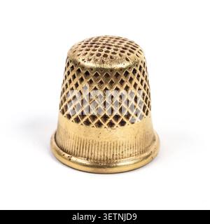 Metal thimble for sewing. Antique copper thimble on a white background. Stock Photo