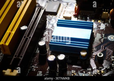 Close-up of a blue aluminum heat sink on an integrated circuit. Thermal performance in microelectronics engineering concept. Stock Photo