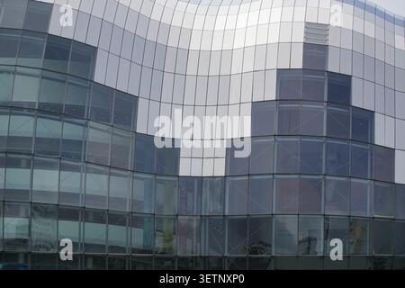 Architectural exterior of The Glasshouse International Centre for Music, showcasing modern curved steel and glass paneling in Gateshead. Stock Photo