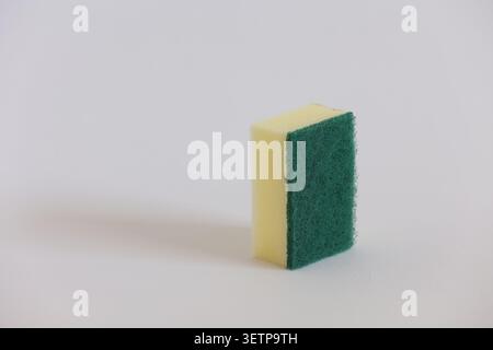 Yellow Kitchen Sponge With Green Scrubber Pad For Cleaning Dishes And Household Surfaces Stock Photo