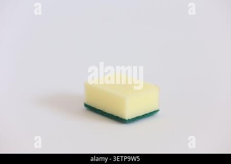 Yellow Kitchen Sponge With Green Scrubber Pad For Cleaning Dishes And Household Surfaces Stock Photo