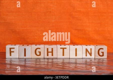 fighting, motivational word made of letters on wooden cubes Stock Photo