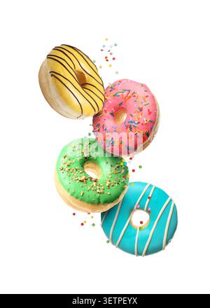 Sweet donuts and sprinkles falling on white background Stock Photo