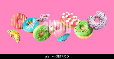 Tasty donuts covered with icing falling on pink background Stock Photo