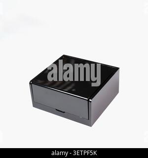 Perspective close up view of a closed minimalist black plastic organizer cube, radiating sleek elegance, mystery, and premium design simplicity Stock Photo