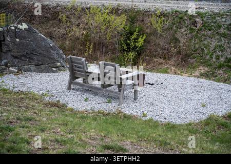 Backyard chairs and fire pit overlooking Jordan Bay on NS Trunk 3 in Jordan Falls, Nova Scotia, Canada Stock Photo