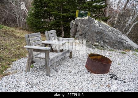 Backyard chairs and fire pit overlooking Jordan Bay on NS Trunk 3 in Jordan Falls, Nova Scotia, Canada Stock Photo