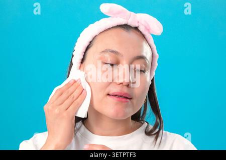 Woman applying makeup in beauty studio Stock Photo