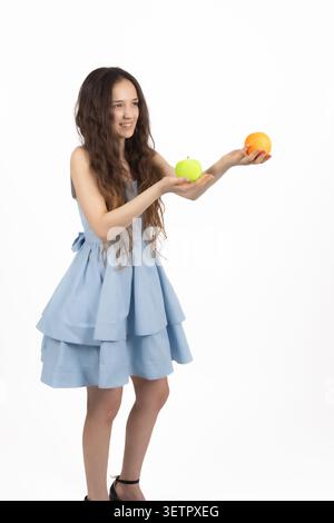 Young woman holding oranges in her hands Stock Photo