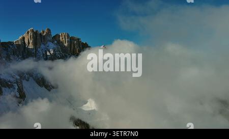 Flying through clouds between mountains Stock Photo