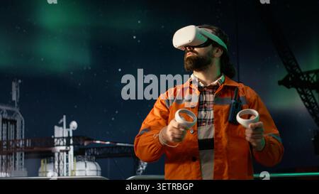 Offshore platform workers using VR headset to monitor fuel shortages caused by embargo slowing operations. Drilling rig colleagues evaluate production with virtual reality during oil crisis, camera A Stock Photo