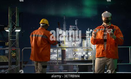 Offshore platform workers using VR headset to monitor fuel shortages caused by embargo slowing operations. Drilling rig colleagues evaluate production with virtual reality during oil crisis, camera A Stock Photo