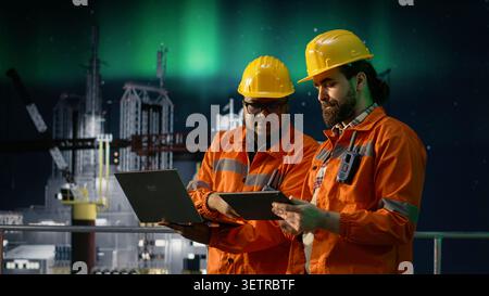 Managing resources, global oil crisis and offshore platform engineering team using laptop. Reviewing petroleum extraction metrics, maritime blockade affecting operations and coworkers, camera A Stock Photo