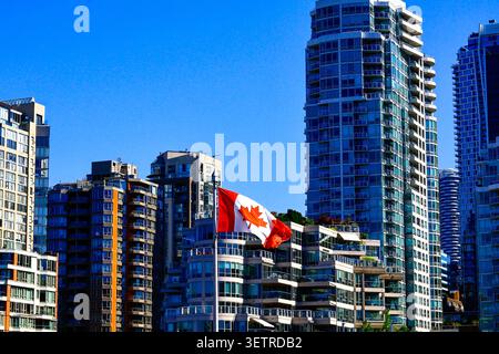A Canadian flag against the city skyline in downtown Vancouver, BC. Stock Photo