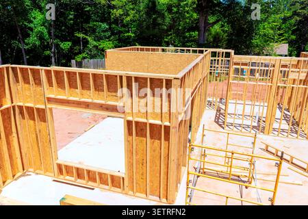 Workers are beams framing new house in residential structure is taking shape. Stock Photo