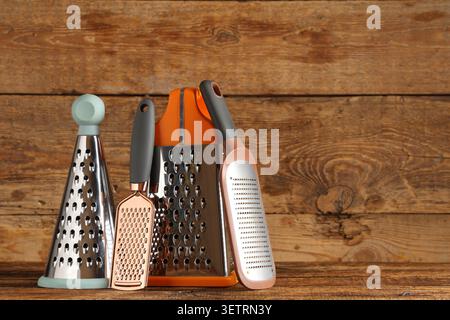 Various kitchen graters on wooden surface Stock Photo