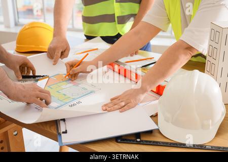 Architects collaborating on building blueprint Stock Photo