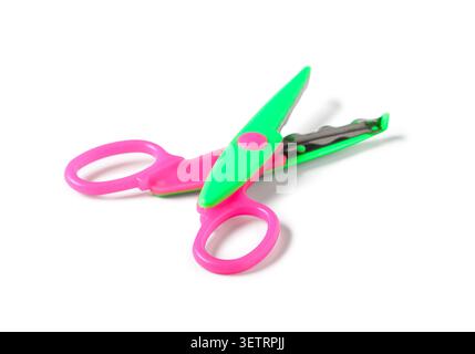 Colorful pink and green craft scissors on white background Stock Photo