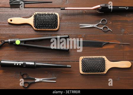 Hair styling tools and accessories on wooden surface Stock Photo